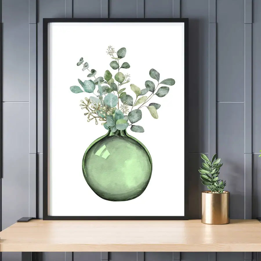 green vase with leaves on a shelf